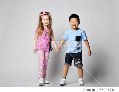 Two frolic happy kids friends Asian boy and Two frolic happy kids friends Asian boy and 77006781