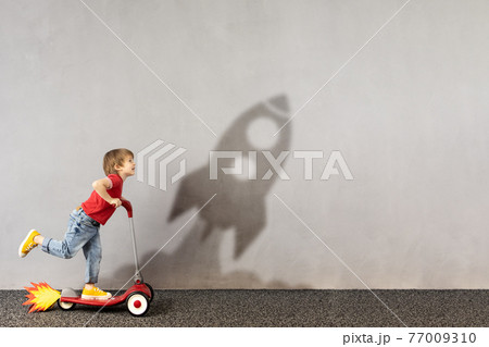 Happy kid dreams about space. Imagination, freedom and motivation concept Happy kid dreams about space. Imagination, freedom and motivation concept 77009310