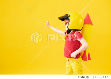 Happy child playing with toy rocket Happy child playing with toy rocket 77009317