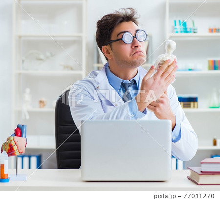 Funny doctor having fun in hospital lab Funny doctor having fun in hospital lab 77011270