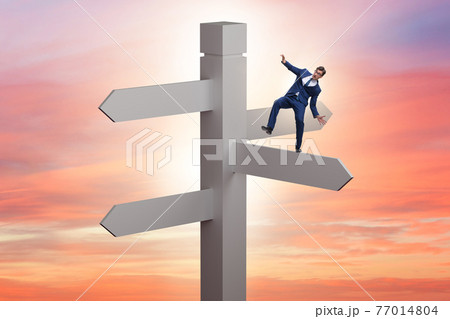 Businessman at the crossroads choosing strategy Businessman at the crossroads choosing strategy 77014804