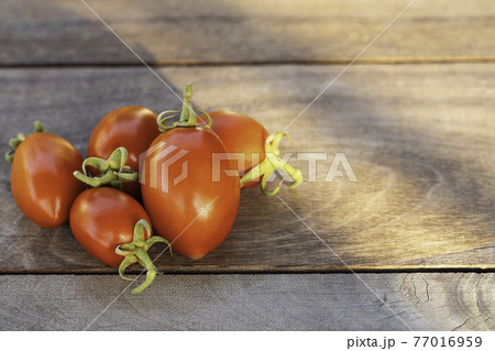 Fresh red tomatoes on vintage wooden table, selective focus Fresh red tomatoes on vintage wooden table, selective focus 77016959
