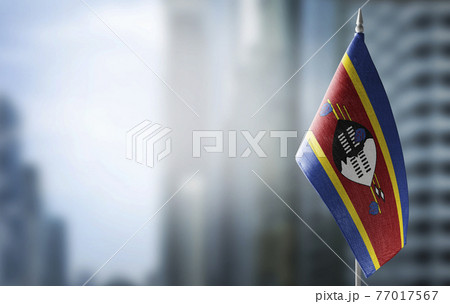 A small flag of Swaziland on the background of a blurred background A small flag of Swaziland on the background of a blurred background 77017567