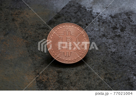 Bitcoin logo coin on rusty metal background 77021004