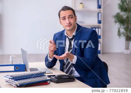 Sick male employee suffering at workplace Sick male employee suffering at workplace 77022859