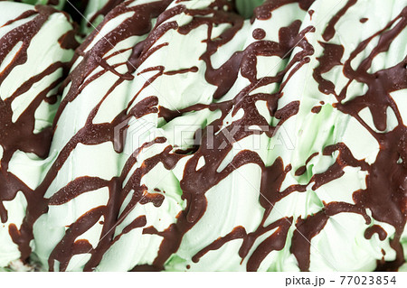 Apple, green ice-cream with chocolate syrop colose-up. Apple, green ice-cream with chocolate syrop colose-up. 77023854