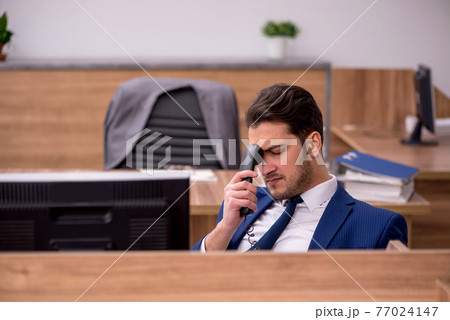Young businessman employee working in the office 77024147