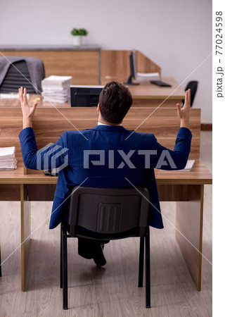 Young businessman employee working in the office 77024598