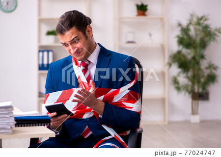 Tied male employee working in the office 77024747