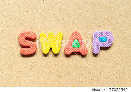 Foam alphabet letter in word swap on wood background 77025545