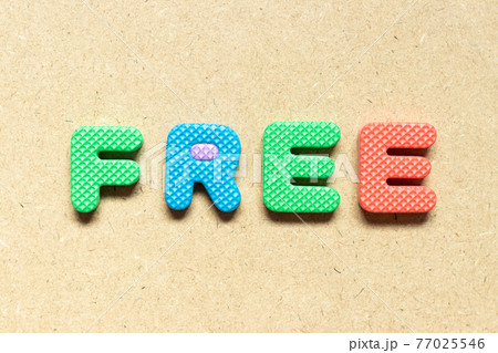 Foam alphabet letter in word free on wood background 77025546