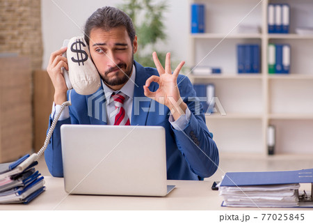 Young male employee in remuneration concept Young male employee in remuneration concept 77025845