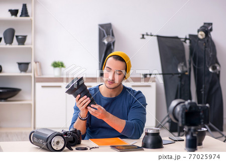 Young male photographer recording video for his blog 77025974
