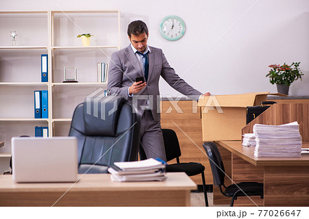 Young male employee being dismissed from his work 77026647