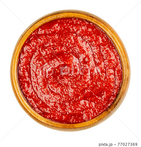 Homemade tomato ketchup in a wooden bowl. Red sweet and tangy table condiment, made from tomato paste, sugar, vinegar and seasonings, served to fried or greasy dishes. Close-up from above, food photo. Homemade tomato ketchup in a wooden bowl. Red sweet and tangy table condiment, made from tomato paste, sugar, vinegar and seasonings, served to fried or greasy dishes. Close-up from above, food photo. 77027369