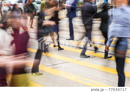 people crossing street on pedestrian crossing, abstract motion blur 77030717