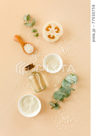Spa treatment concept. Natural, Organic spa cosmetics products with eucalyptus oil, sea salt, massage brush, eucalyptus leaf extract. Spa background 77030758