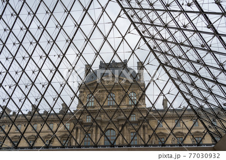 View of Louvre Museum from inside the glass Pyramid in Paris, France. View of Louvre Museum from inside the glass Pyramid in Paris, France. 77030932