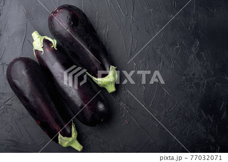 Healthy and delicious purple eggplants, on black stone background, top view flat lay, with copy space for text Healthy and delicious purple eggplants, on black stone background, top view flat lay, with copy space for text 77032071