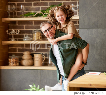 Young joyful father and daughter playing together at home 77032083