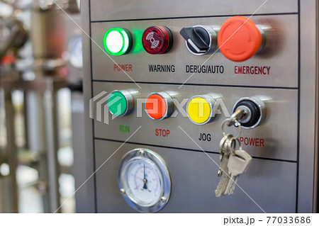 Machine control panel with push buttons and switches at factory Machine control panel with push buttons and switches at factory 77033686