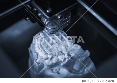 3D printer prints the form of molten plastic white. 3D printer prints the form of molten plastic white. 77034020