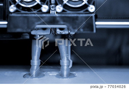 3D printer prints the form of molten plastic green. 3D printer prints the form of molten plastic green. 77034026