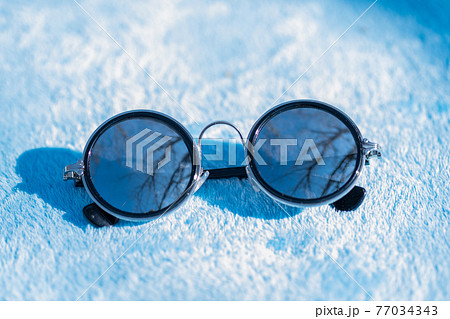 Classic sunglasses classic design with silver lenses shoot in a sunny day of summer closeup. Selective Focus 77034343