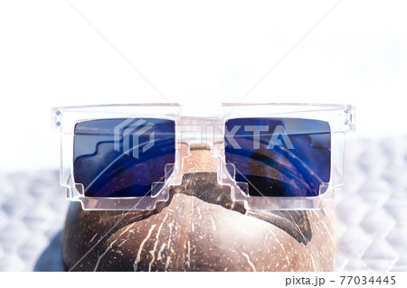 Blue lenses pixel sunglasses model shoot in a summer day closeup. Selective focus Blue lenses pixel sunglasses model shoot in a summer day closeup. Selective focus 77034445