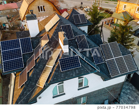 Aerial view of solar photovoltaic panels on a house roof Aerial view of solar photovoltaic panels on a house roof 77034798