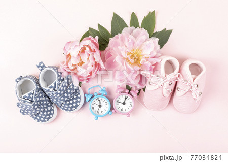 Girl and boy shoes with pink and blue watches on pink  77034824