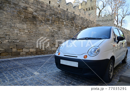 White subcompact car on the street of Baku White subcompact car on the street of Baku 77035291