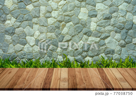 Empty wood table with stone wall texture background. For display or montage your products. Empty wood table with stone wall texture background. For display or montage your products. 77038750
