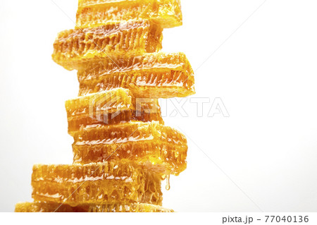 portions of fresh honeycomb on a white background. vitamin natural food. bee work product portions of fresh honeycomb on a white background. vitamin natural food. bee work product 77040136
