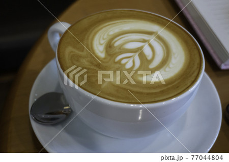 A cup of latte on the table A cup of latte on the table 77044804