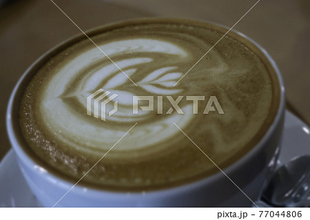 A cup of latte on the table A cup of latte on the table 77044806