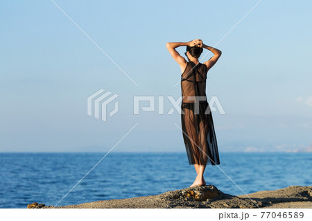 young slim gitl looking to the ocean 77046589