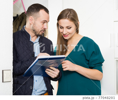 Caseworker helping woman polling questionnaire 77048201