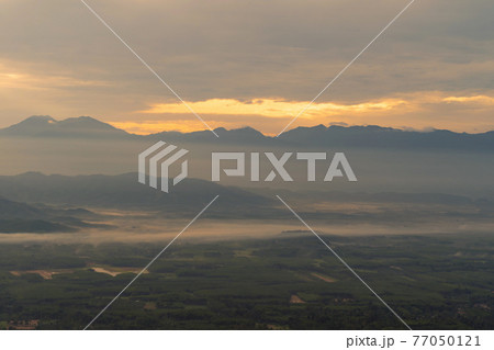 Aerial top view of forest trees with fog mist and green mountain hill at sunset. Nature landscape background, Thailand. 77050121