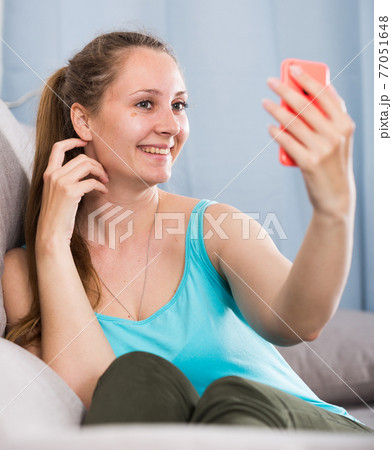 Woman using phone 77051648