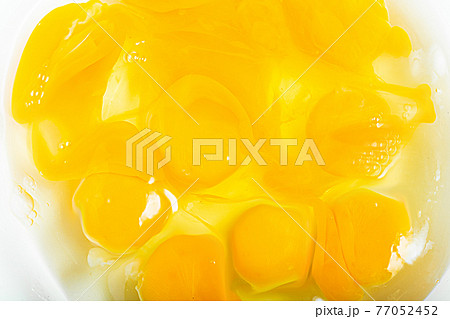 溶き卵　かき混ぜる途中の生卵 77052452