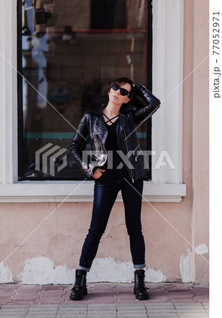 Fashion model in sunglasses and leather jacket Fashion model in sunglasses and leather jacket 77052971