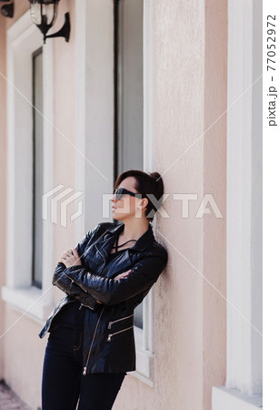 stylish brunette woman in a leather jacket stylish brunette woman in a leather jacket 77052972