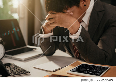 Portrait unhappy young business man worried and sad from business from COVID-19. Portrait unhappy young business man worried and sad from business from COVID-19. 77054589