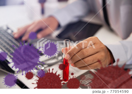 Medical or research scientist or doctor using looking at a test tube of clear solution in a lab or laboratory. Medical or research scientist or doctor using looking at a test tube of clear solution in a lab or laboratory. 77054590
