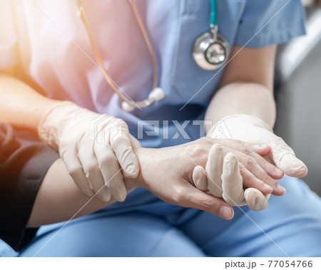 Surgeon, surgical doctor, anesthetist or anesthesiologist holding patient's hand for health care trust and support in professional ER surgical operation, medical anesthetic safety, healthcare concept 77054766