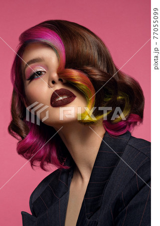 Beautiful woman with multi-colored hair and bright make up and hairstyle. 77055099