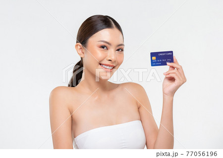 Youthful smiling Asian woman showing credit card for beauty promotion and payment concepts Youthful smiling Asian woman showing credit card for beauty promotion and payment concepts 77056196
