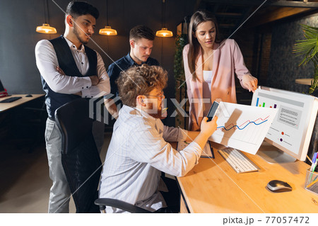 Colleagues working together in modern office using devices and gadgets during creative meeting 77057472