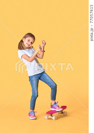 Stylish funny girl wearing white t-shirt, blue jeans and sneaker 77057615